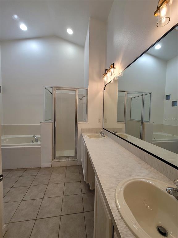 601 Astor Drive Haines City, FL 33844 - Photo 15 of 18 a spacious bathroom with a granite countertop sink a toilet a mirror and bathtub