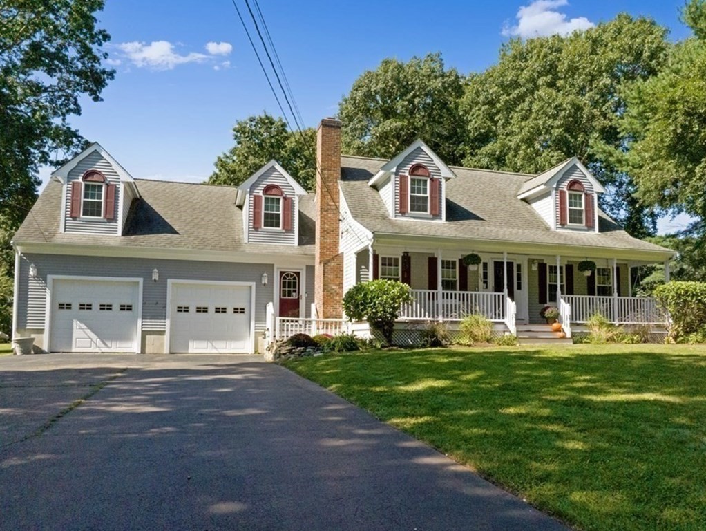 304 Mill Road Fairhaven, MA 02719 - Photo 1 of 35 a front view of a house with a yard table and chairs