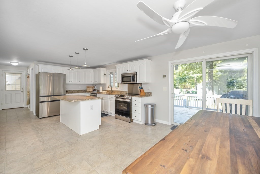 304 Mill Road Fairhaven, MA 02719 - Photo 12 of 35 a kitchen with refrigerator cabinets and furniture