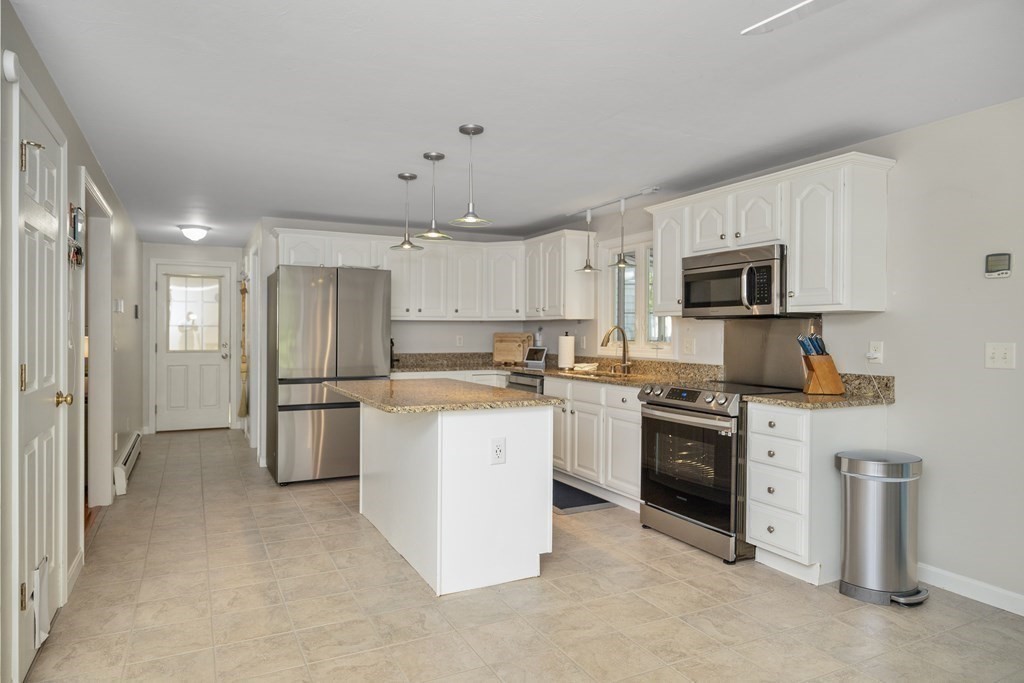 304 Mill Road Fairhaven, MA 02719 - Photo 13 of 35 a kitchen with a refrigerator stove and microwave