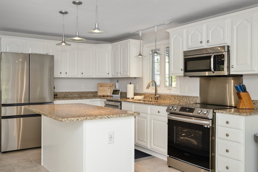 304 Mill Road Fairhaven, MA 02719 - Photo 14 of 35 a kitchen with granite countertop white cabinets white stainless steel appliances and a sink