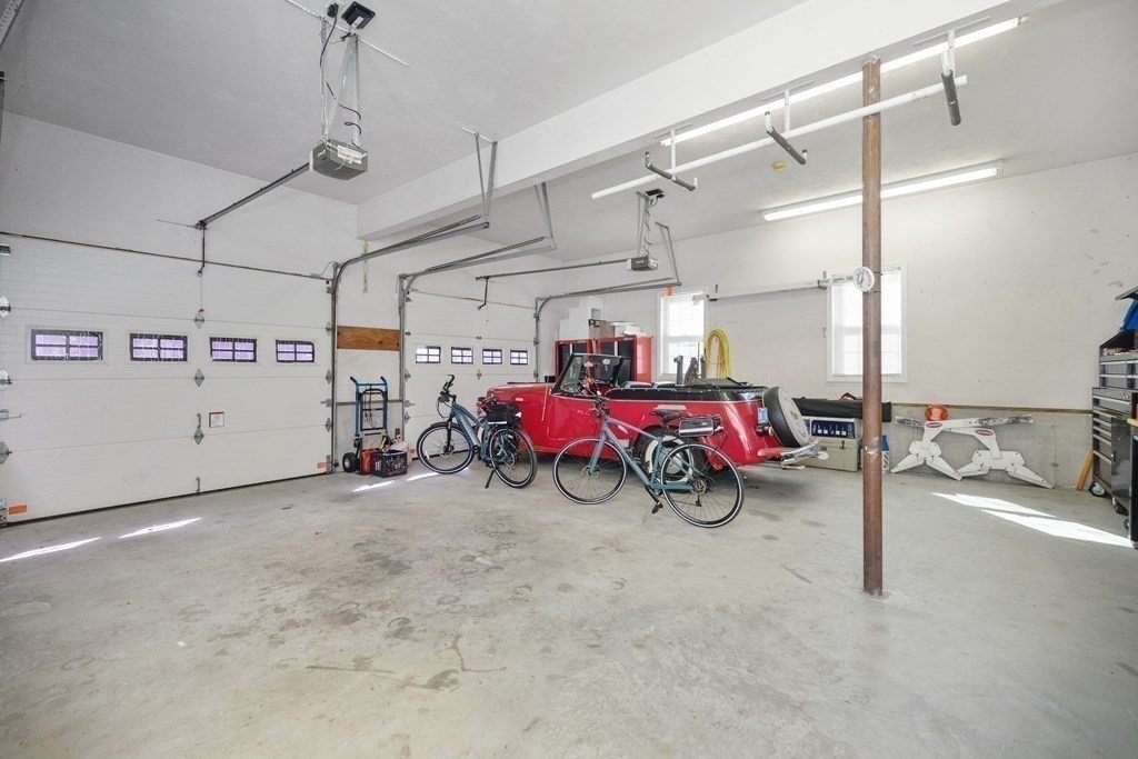 304 Mill Road Fairhaven, MA 02719 - Photo 35 of 35 a view of a garage with racks and white walls
