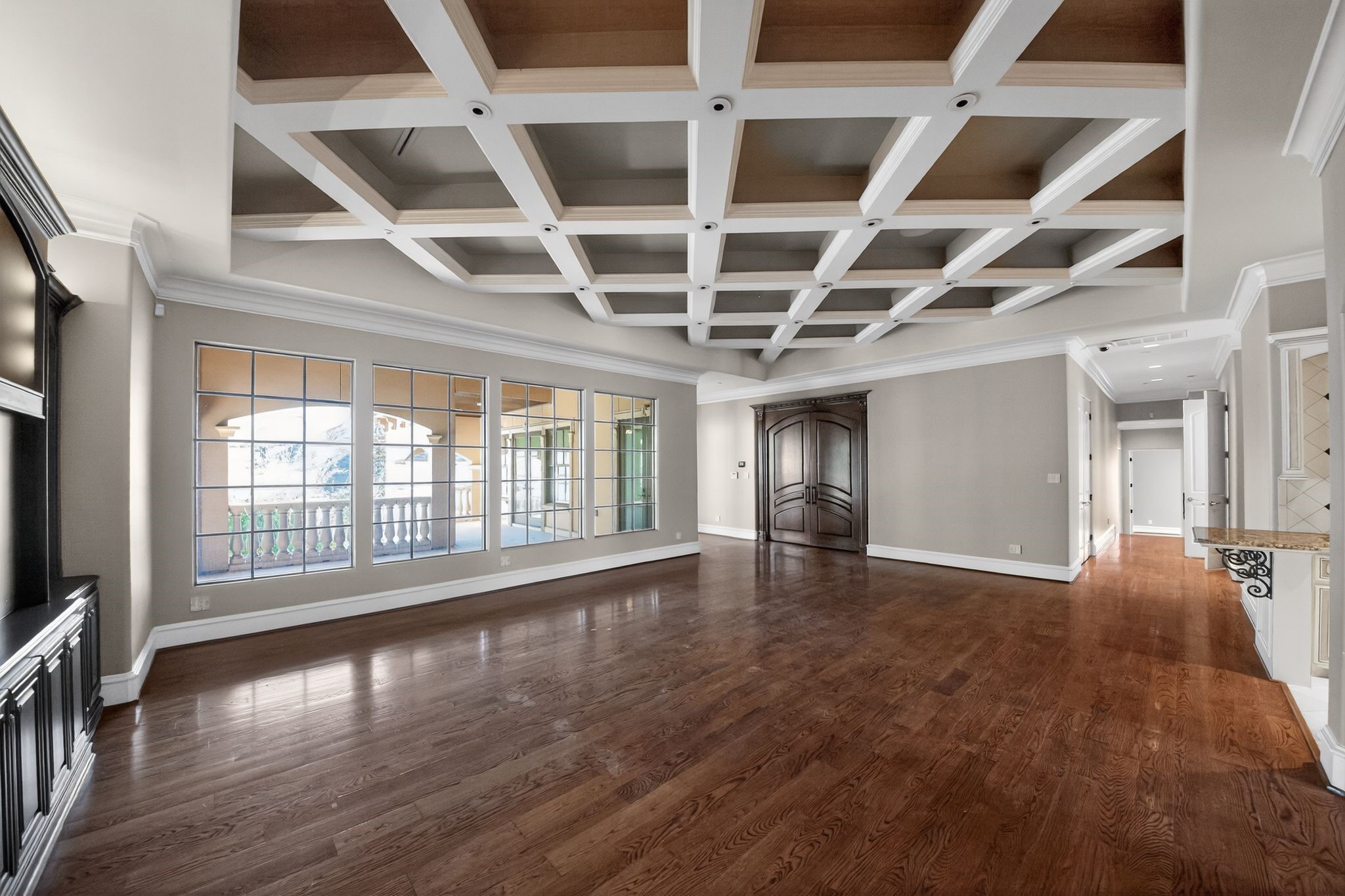 11117 Beinhorn Road Houston, TX 77024 - Photo 11 of 48 wooden floor in an empty room with a window