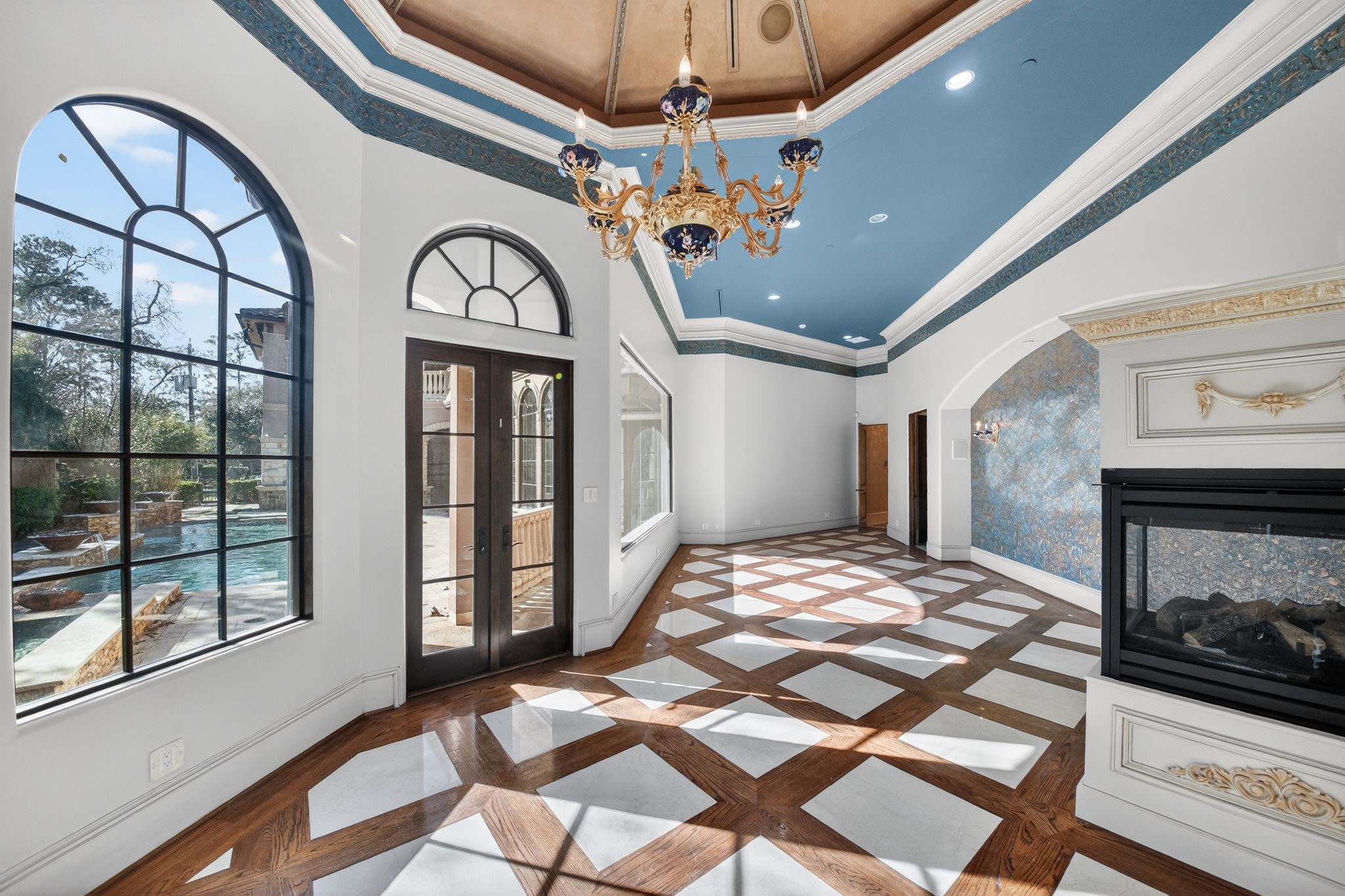 11117 Beinhorn Road Houston, TX 77024 - Photo 13 of 48 a bedroom with a bed a mirror and a large window with the outer view