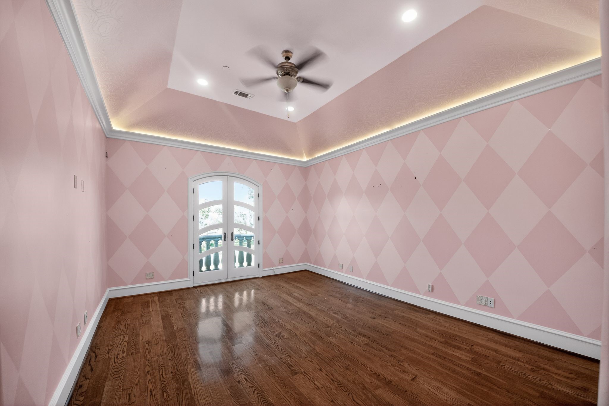 11117 Beinhorn Road Houston, TX 77024 - Photo 19 of 48 wooden floor in an empty room with a window