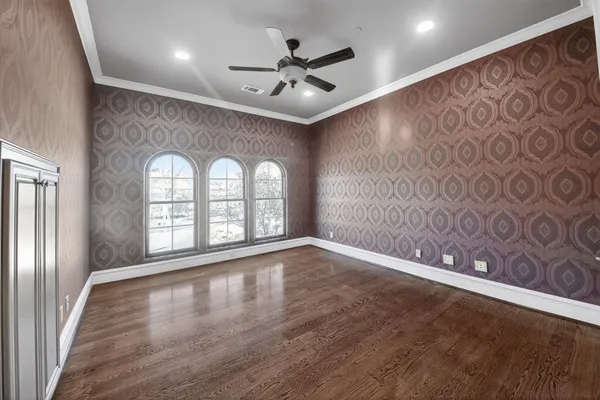 a view of a hallway with wooden floor and a window