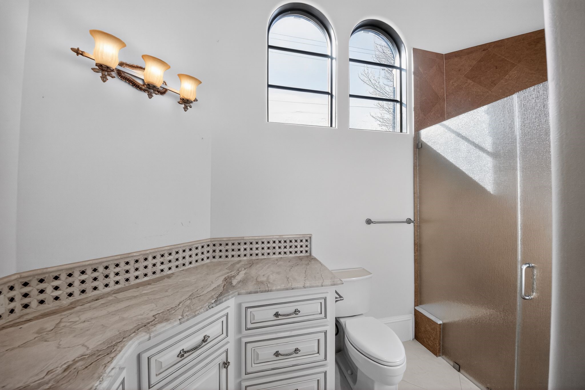11117 Beinhorn Road Houston, TX 77024 - Photo 35 of 48 a bathroom with a granite countertop sink a toilet and a mirror