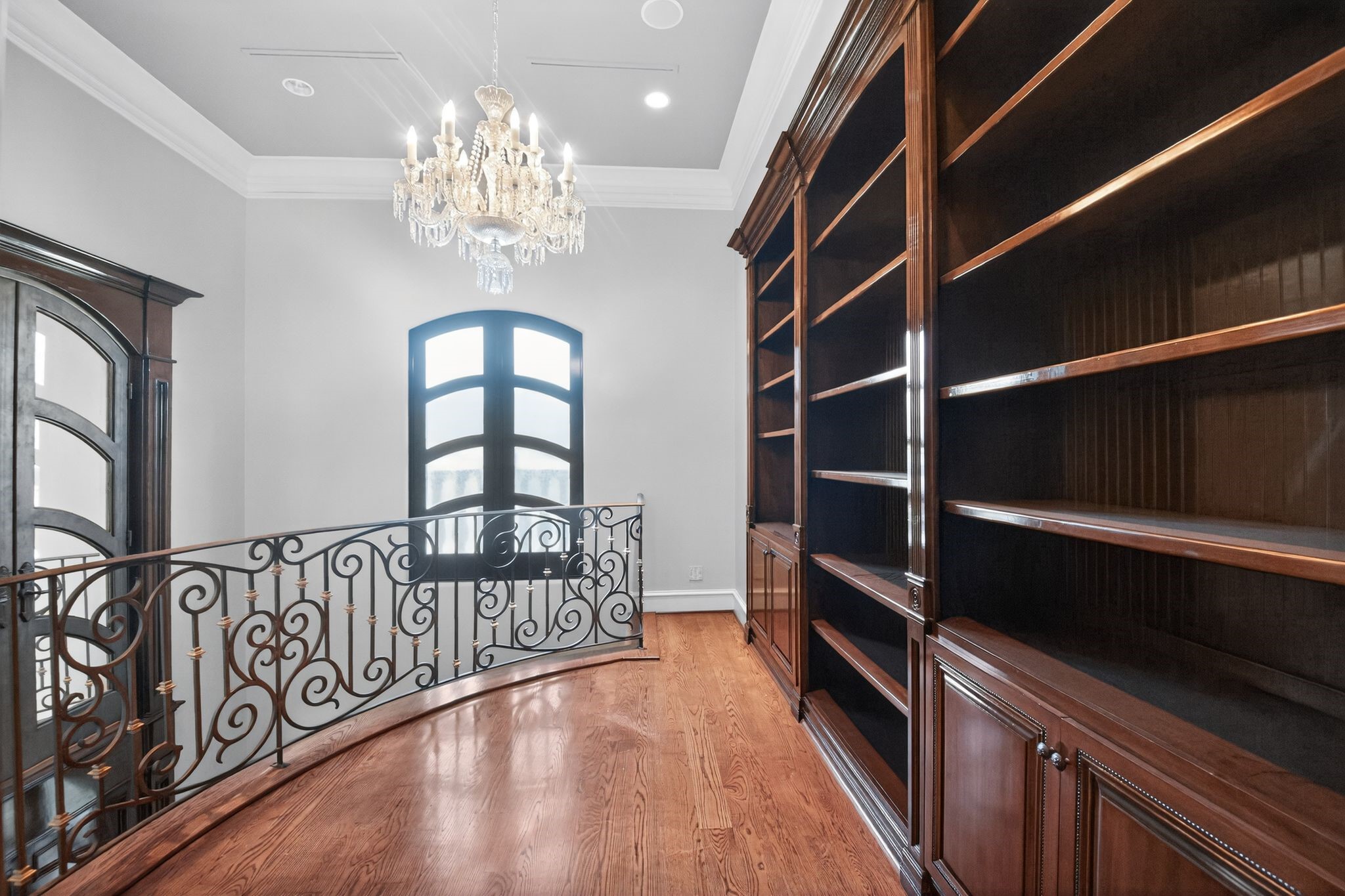 11117 Beinhorn Road Houston, TX 77024 - Photo 41 of 48 a view of a hallway with wooden floor and a window