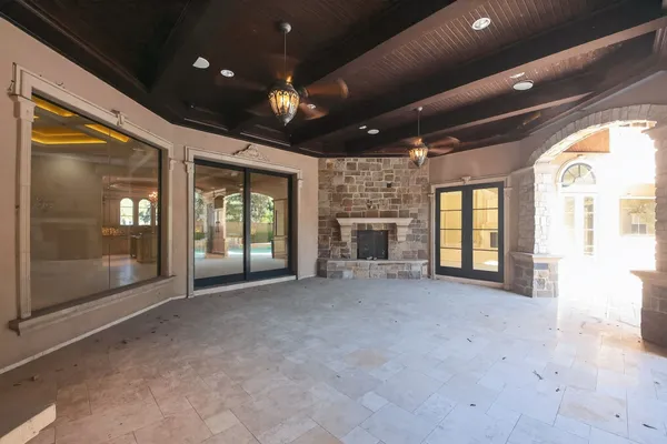 an empty room with a window and a ceiling fan