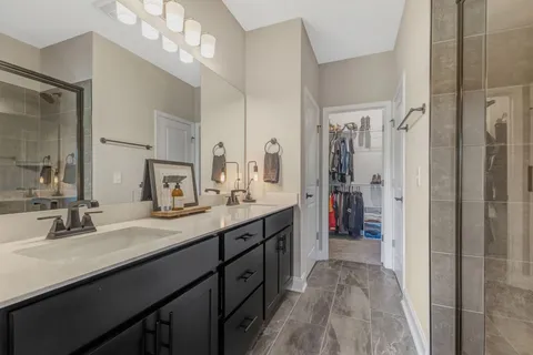 a bathroom with a glass shower door