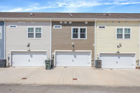 a front view of residential houses with yard and swimming pool