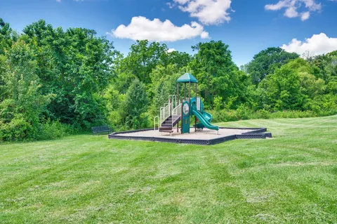 a sign broad in front of red brick house