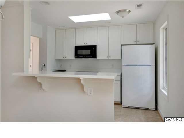 195 North Bennington Road Charlottesville, VA 22901 - Photo 8 of 19 a kitchen with white cabinets and refrigerator