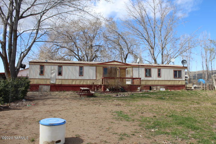 2812 Cook Road Yakima, WA 98908 - Photo 8 of 9 a view of a white house with a big yard and large trees