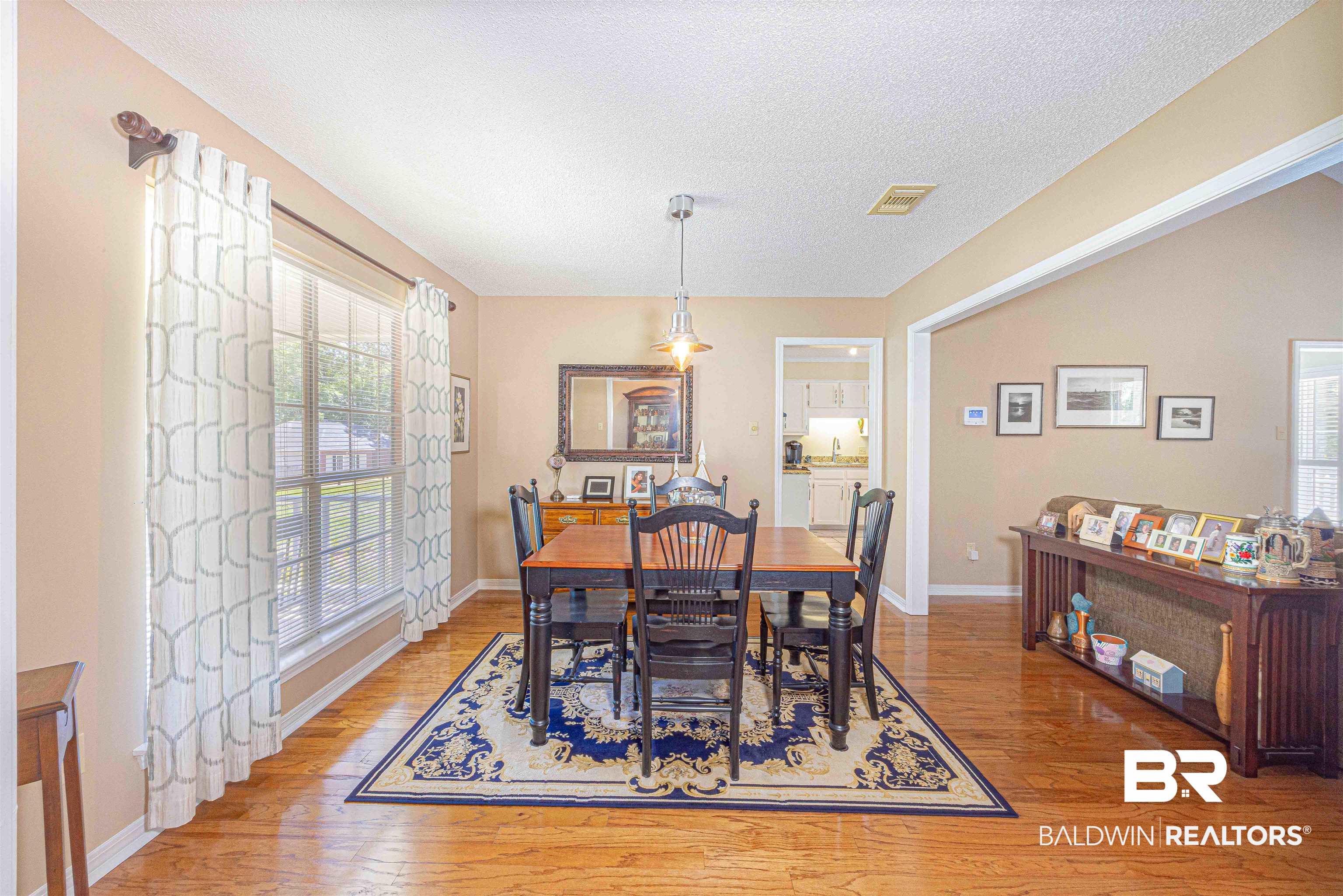 485 Ridgewood Drive Daphne, AL 36526 - Photo 8 of 38 Dining space with baseboards, light wood-style flooring, visible vents, and a textured ceiling