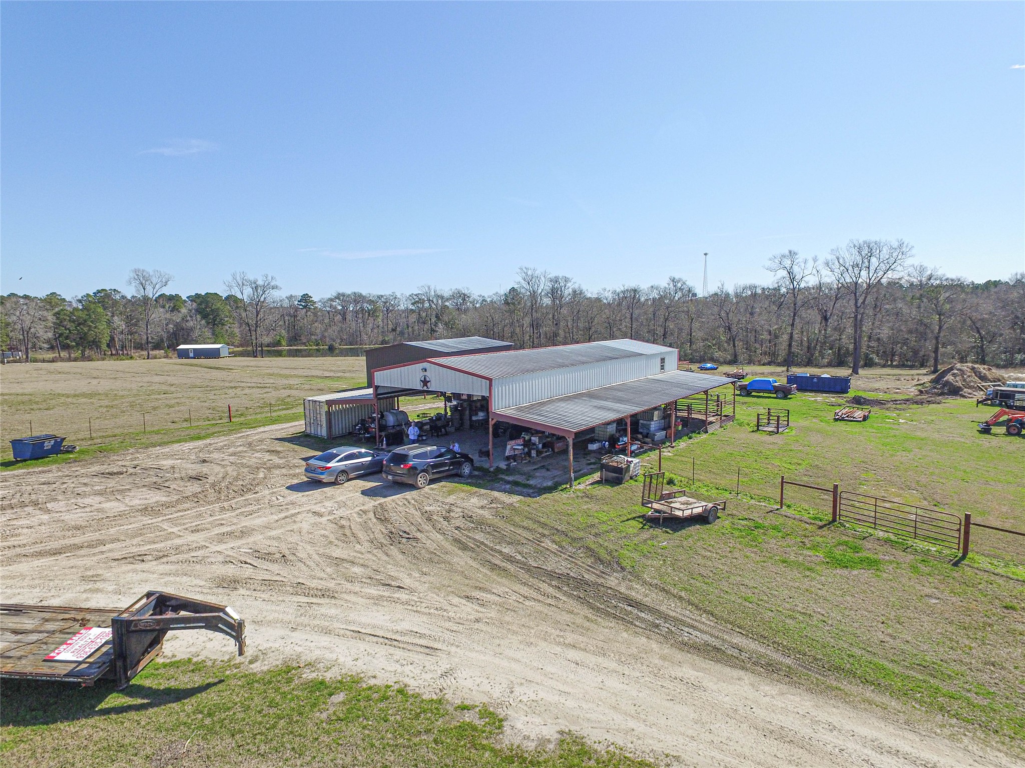 684 Hooks Road Corrigan, TX 75939 - Photo 3 of 34 a view of a lake with lawn chairs and large trees