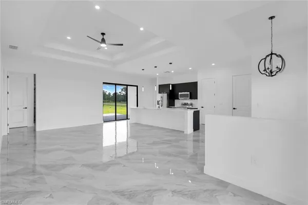 a view of a kitchen with microwave and cabinets