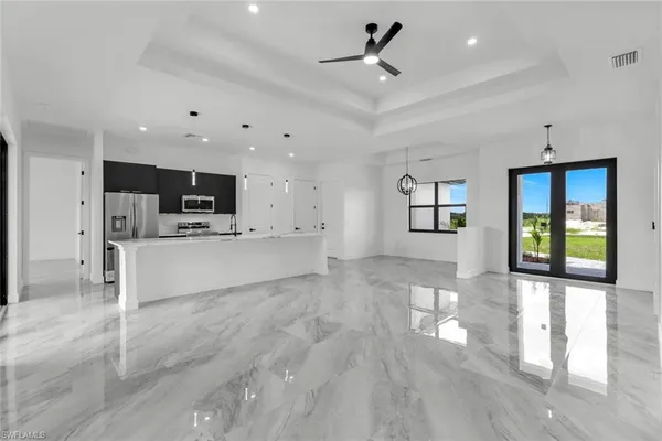 a view of kitchen with cabinets and refrigerator
