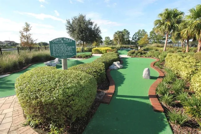 a front view of a house with a yard and lake view