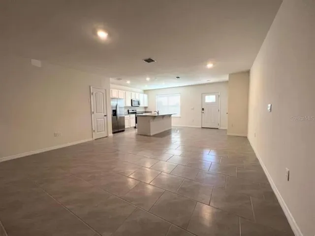a view of a kitchen with a sink and cabinets