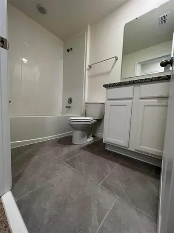 a living room with a sink and a toilet