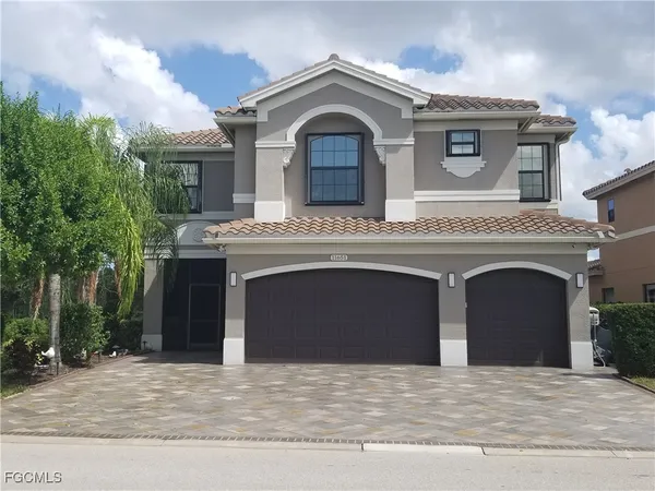 a view of a house with a balcony and front door