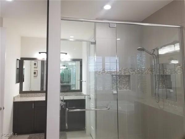 a bathroom with a shower and a sink