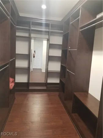 a view of walk in closet with empty racks