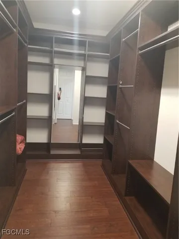 a view of walk in closet with empty racks