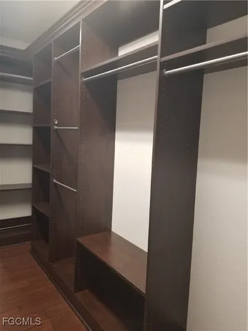 a view of walk in closet with empty racks