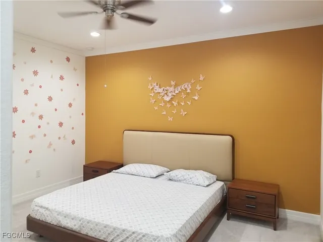 a bedroom with a bed and a ceiling fan