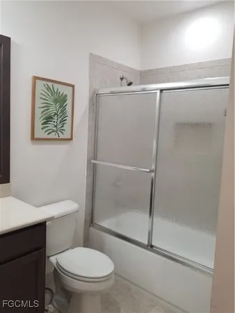 a bathroom with a shower a toilet and a sink