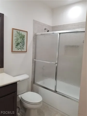 a bathroom with a shower a toilet and a sink