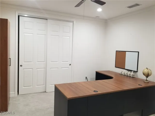 a bedroom with a bed and a desk