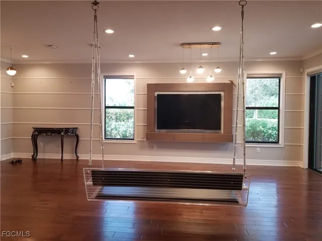 a living room with a flat screen tv and a fireplace