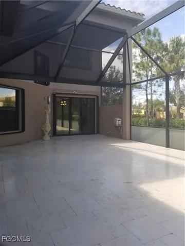 a large kitchen with kitchen island a large window in it