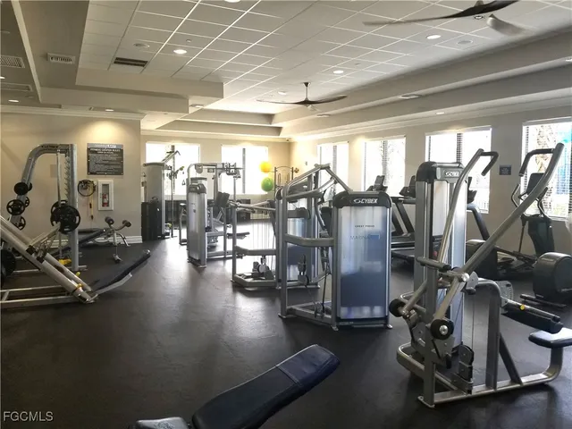 a room with pool table and windows