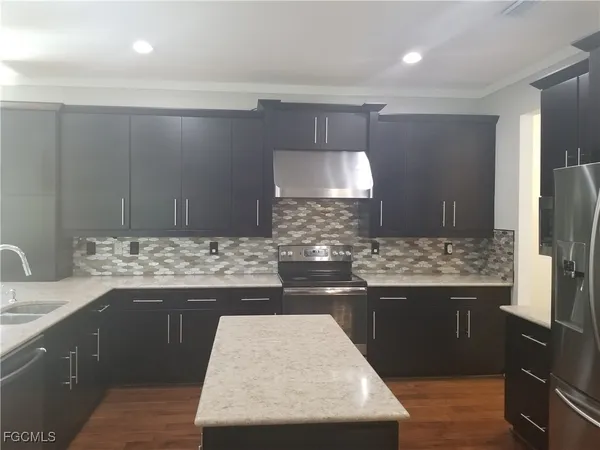 a kitchen with a sink and a refrigerator