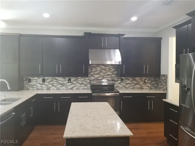 a kitchen with a sink and a refrigerator