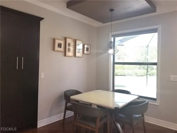 a view of a dining room with a table and chairs