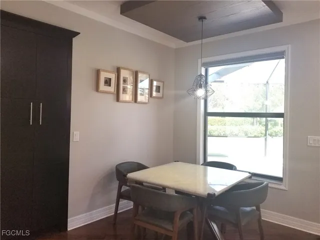 a view of a dining room with a table and chairs