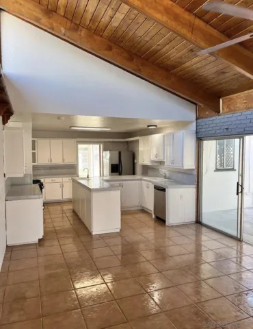 a large kitchen with a large counter top appliances and cabinets