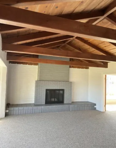 a view of empty room with a fireplace