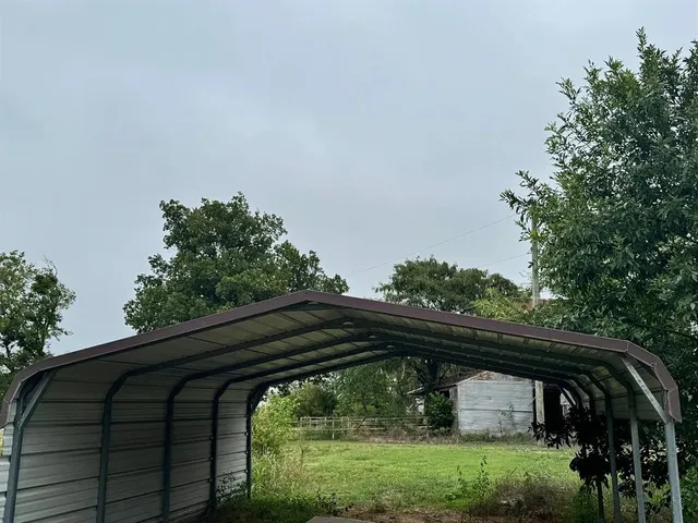 a view of a porch with furniture and large windows