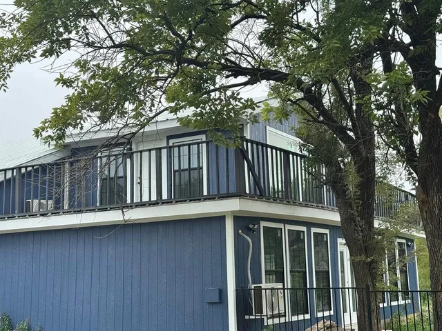a view of backyard with barbeque and trees
