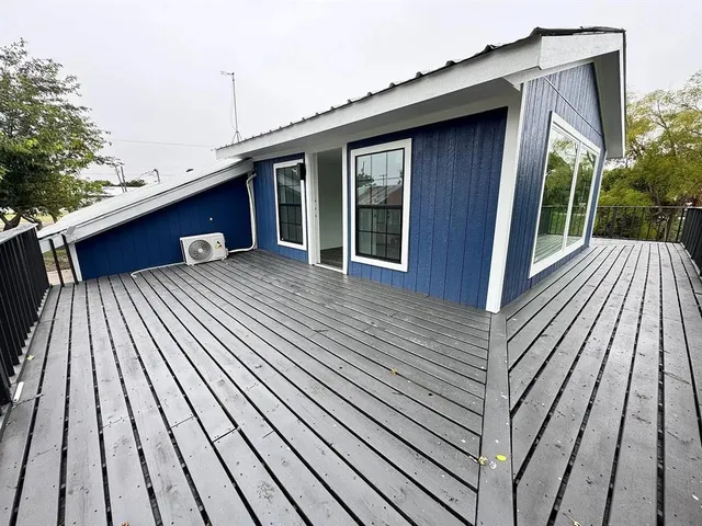 a view of a house with a window and wooden fence