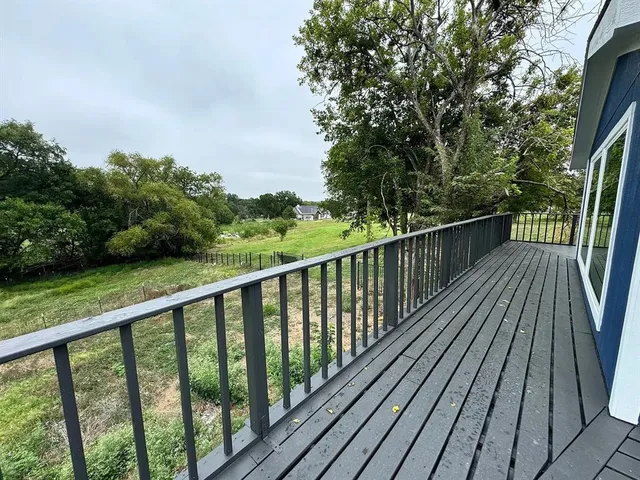 a view of backyard with a deck