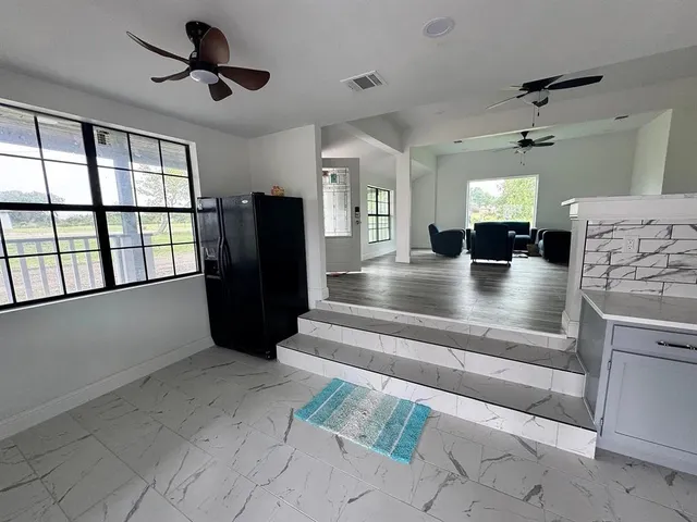 a large kitchen with a table and chairs