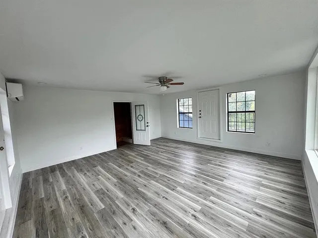 a view of a living room and kitchen with a large window