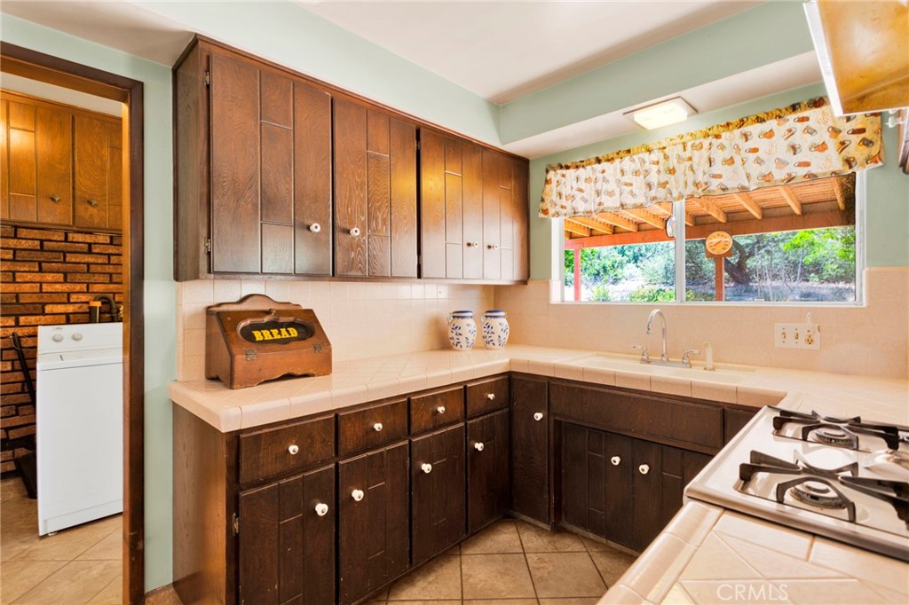 5500 Oil Well Road Phelan, CA 92371 - Photo 8 of 65 a kitchen with a sink and a stove next to a window